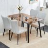 One table and 4 light gray PU chairs. Rectangular tea brown glass dining table, tempered glass tabletop and black metal legs, suitable for kitchen